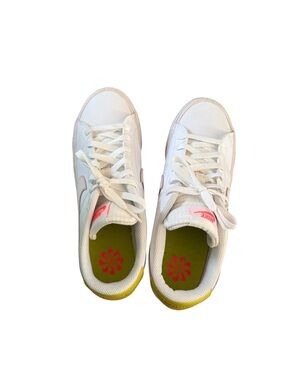 Nike White Low-Top Sneakers with Pink Swoosh and Yellow Heel